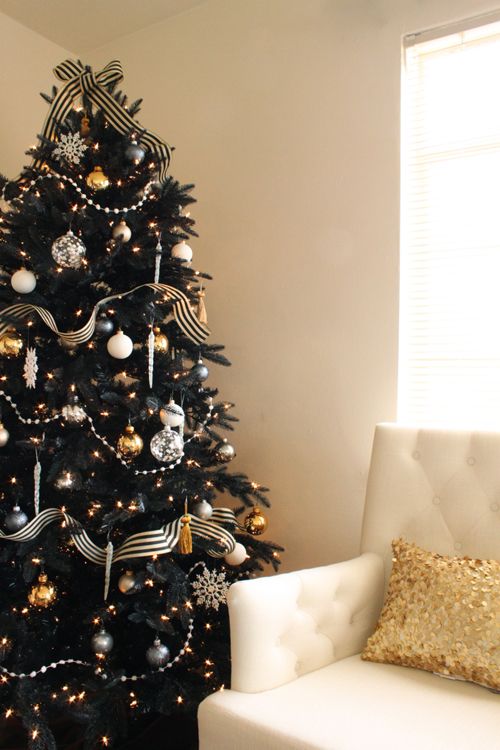 refined black Christmas tree with striped ribbon, silver and gold ornaments