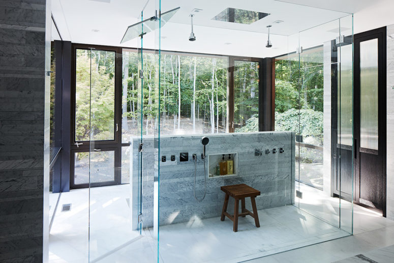 The bathroom features a glass cube shower and extensive glazing to catch all the best of the views