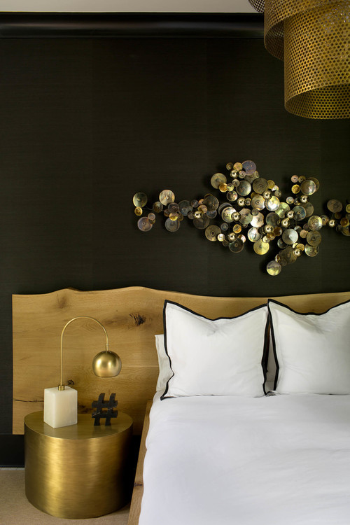 The focal point of the bedroom is a metallic wall art and its black and gold combo is refined