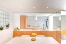 06 The kitchen is light-filled, with warm and light wood cabinetry that keeps the look modern yet inviting and cozy