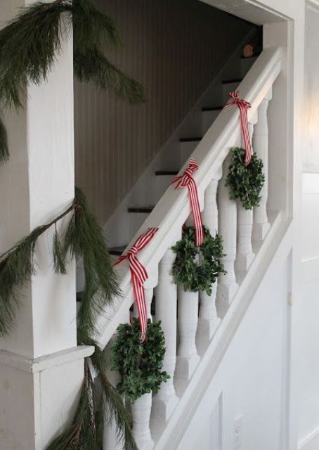 eucalyptus wreaths with striped ribbon and a fir garland