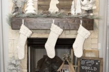 06 rustic mantel with pinecones and wood logs, white stockings and a barnwood sign to refresh the look