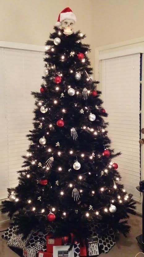 Nightmare before Christmas inspired black tree with lights, red and silver ornaments and skeleton hands