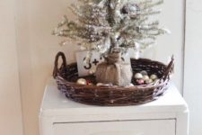 07 a silver tree wrapped with burlap, placed into a basket with ornaments