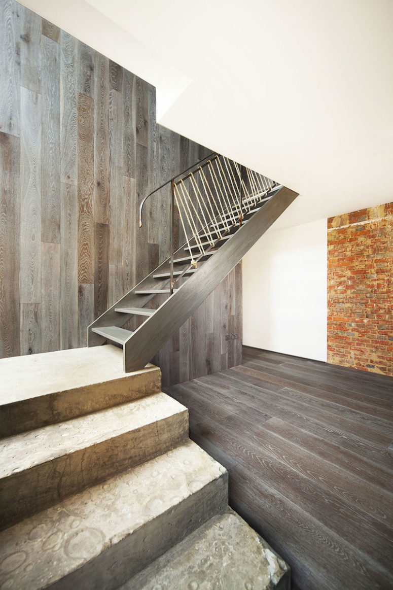The wood-clad accent wall allows the staircase to blend in more easily