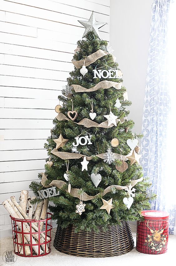 A classic rustic Christmas tree decorated with white ornaments and burlap and placed in a basket is a very cool and eye catchy idea to rock