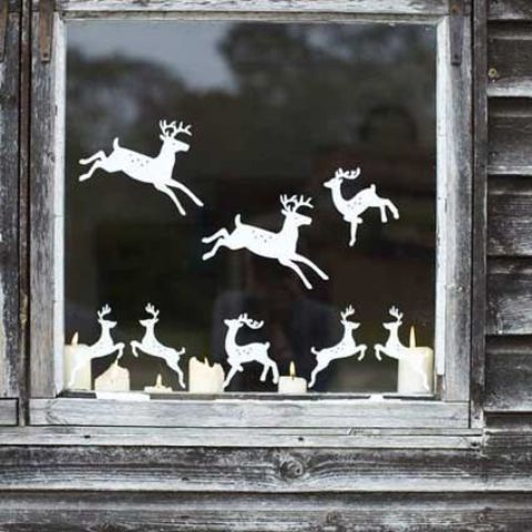 cut out reindeer from paper and attach them to the window creating your own look