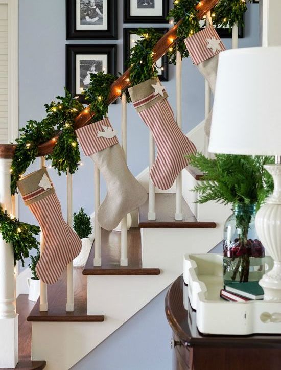 evergreen garland that wraps the banister and striped stockings