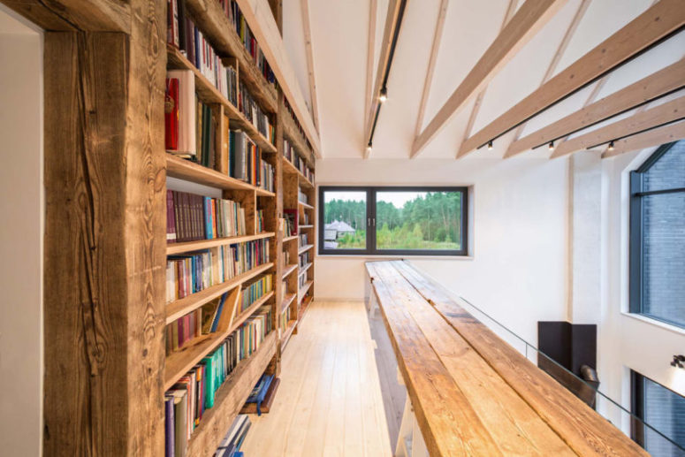 There's a library area on the upper floor, with large bookcases and a simple wooden bench