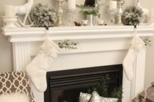 09 neutral mantel decor with silver candle holders and vases, a deer and flocked fir balls