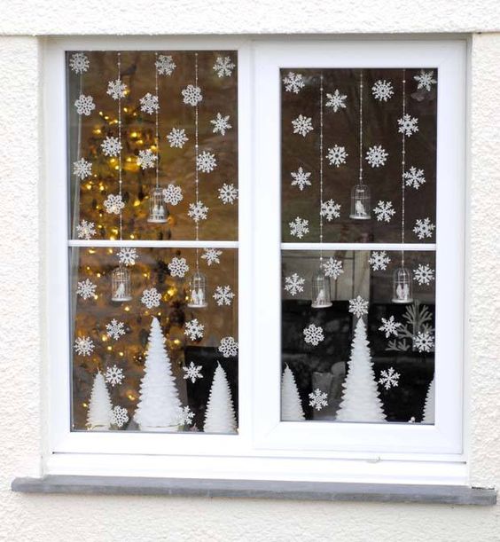small paper snowflakes and white trees for simple window decor
