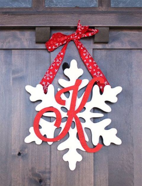 snowflake door hanger with a monogram and red ribbon