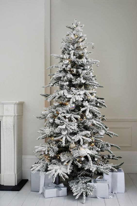 Alaskan fir tree with silver ornaments looks very modern and chic