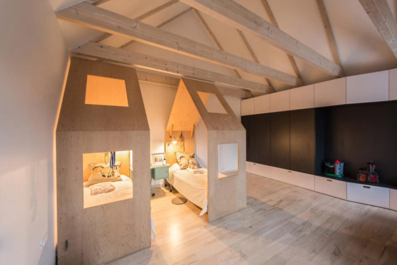 The kids' room is also modern, with sleek wardrobes and house-shaped beds to make the space cozy and private
