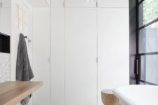 10 The main bathroom is a laundry room, too, but everything is hidden behind the folding doors for a sleek uncluttered look