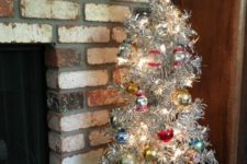 10 aluminum Christmas tree with bold vintage ornaments and ornaments displayed in the crate