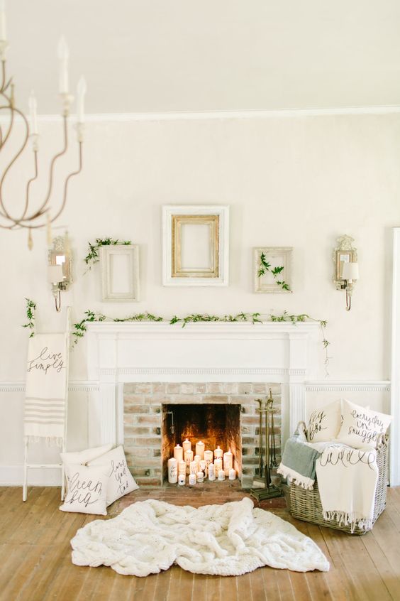foliage garland, candles in a non-working fireplace and blankets in a basket