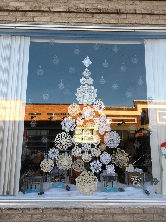 paper snowflakes attached to the window
