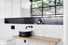 12 Light patterned tiles, black decor and a wooden counter stick to the modern decor used around the house