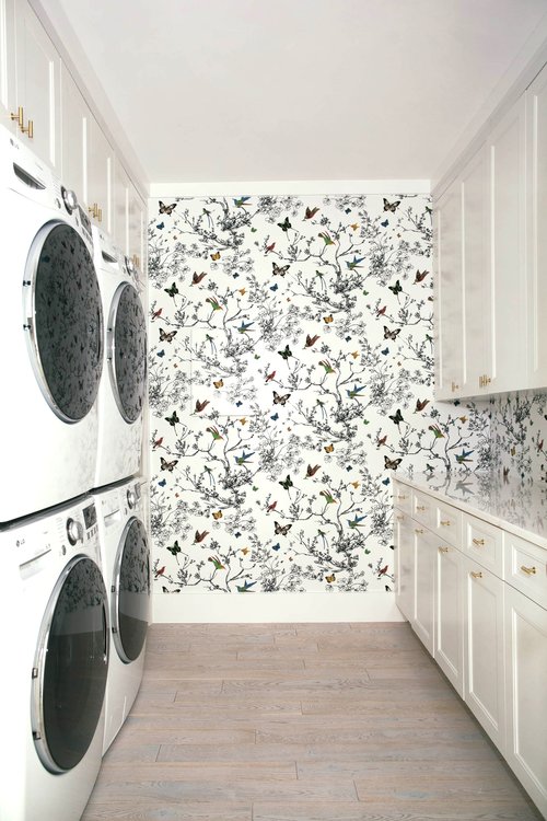 The laundry room is spacious and comfy, with flora and fauna print wallpaper