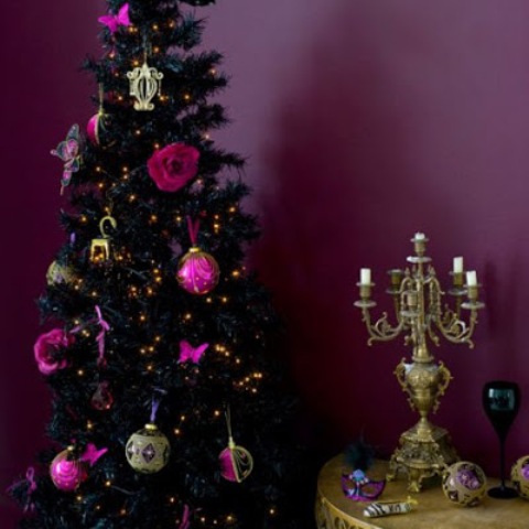 a dramatic, glam and burlesque black tree with rose and bauble ornaments