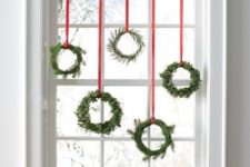 12 an assortment of small evergreen wreaths with red ribbon