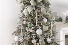 12 darker silver tree decorated with olive green ornaments and fabric garlands, wwhite and silver ornaments and snowflakes