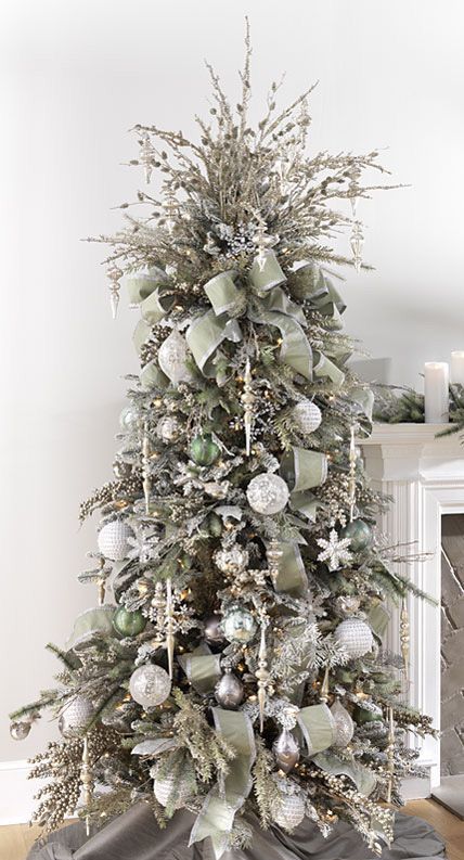 darker silver tree decorated with olive green ornaments and fabric garlands, wwhite and silver ornaments and snowflakes
