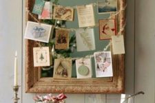 13 a framed mirror with garlands and  hanging photos and cards on them