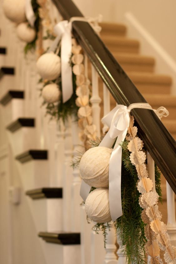 fabric wrapped ornaments, evergreens and bows on the banister