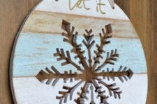 14 Let It Snow door hanger with a snowflake cut out in it