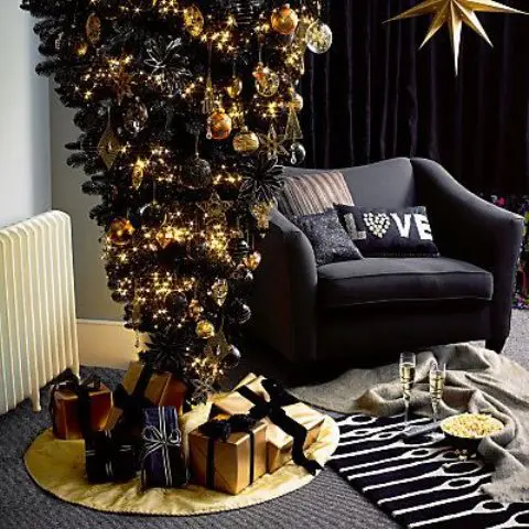 a black upside down Christmas tree with black and gold decor