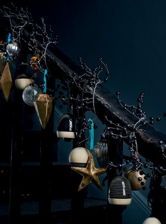 dark Christmas stairs decor with bells, black berries and vintage ornaments