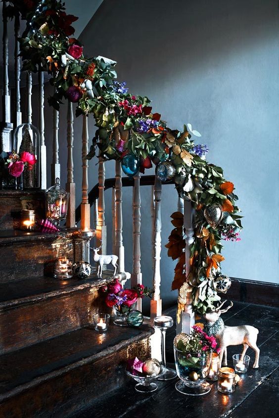 faux leaves and flowers with colorful baubles for different staircase decor