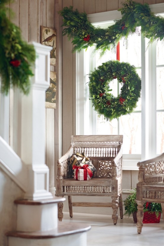 lush evergreen wreaths and garlands are a timeless option that fits any interior