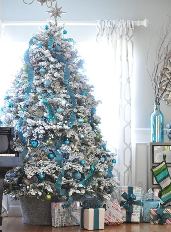 turquoise ornaments and garlands on a flocked Christmas tree