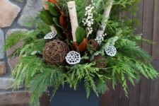 15 a holiday container with evergreens, branches, lotus