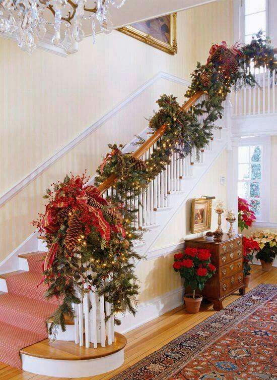 fir garland with large pinecones, lights and red ribbon decor