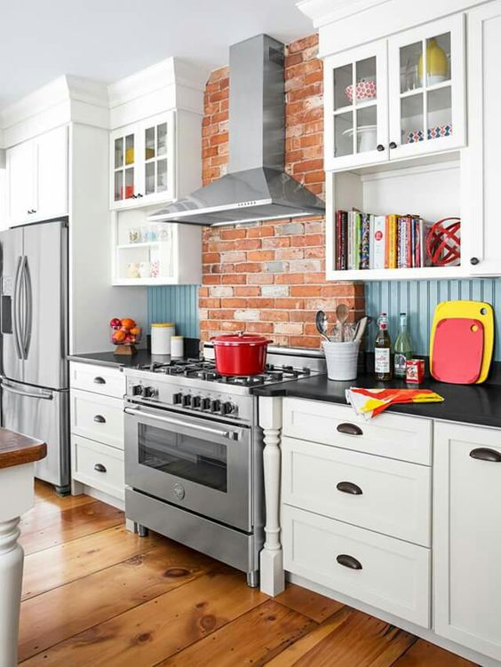 red brick, blue beadboard backsplash and white cabinets look cheerful and eye-catching together