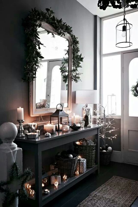 decorate your entryway in moody colors and spruce the decor with lots of candles and lights