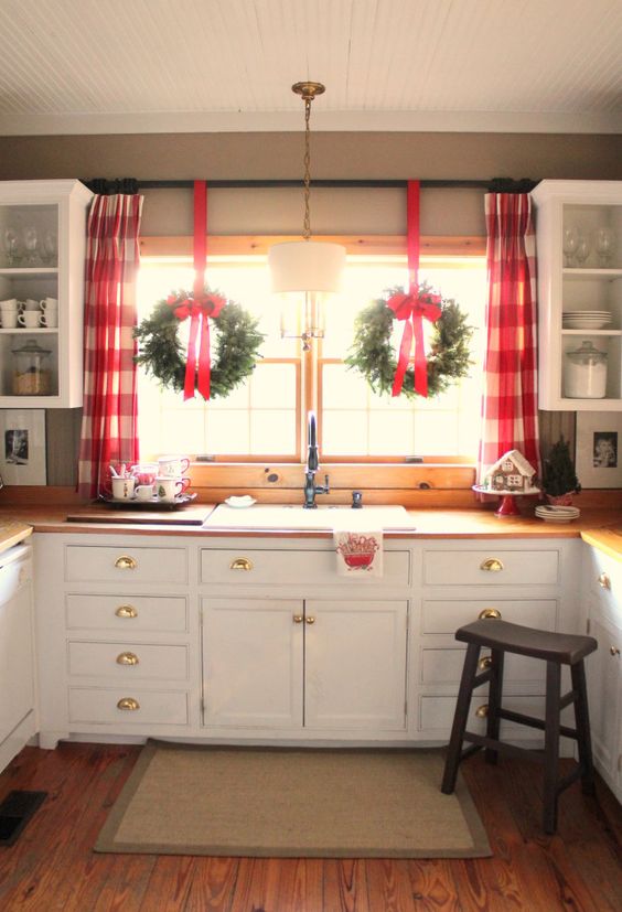 red plaid curtains and wreaths with red bows