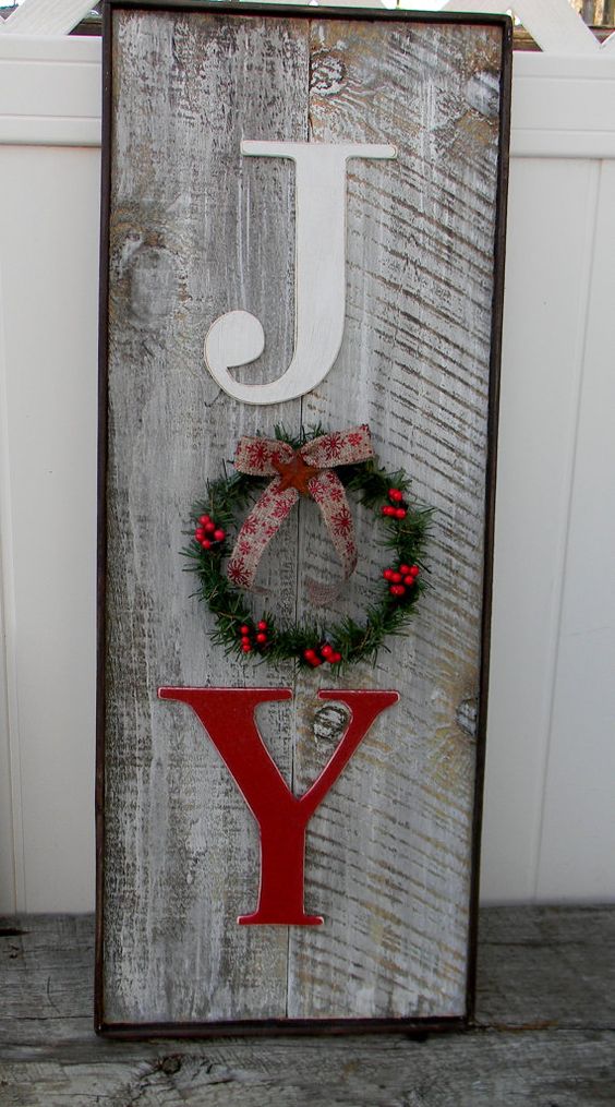 weathered wooden JOY sign with a small wreath