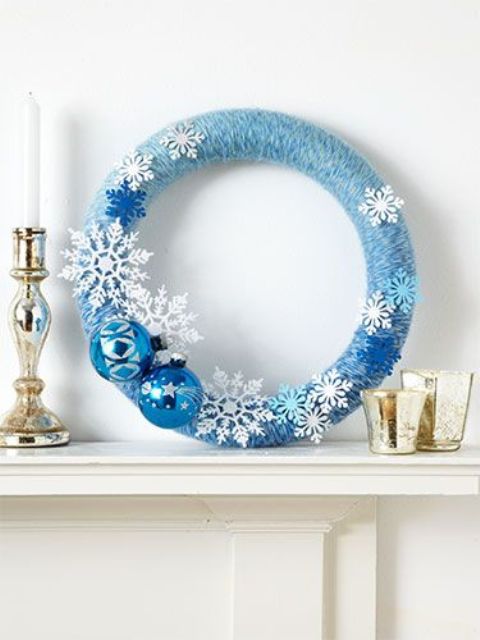 a blue an white Christmas wreath with snowflakes and ornaments