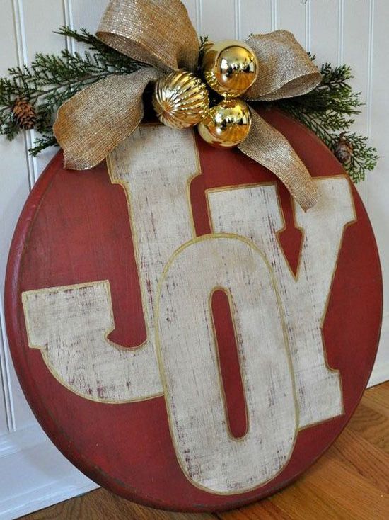 red ornament JOY sign with gold ornaments and a burlap bow