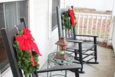 17 small wreaths with red bows hung on the rockers