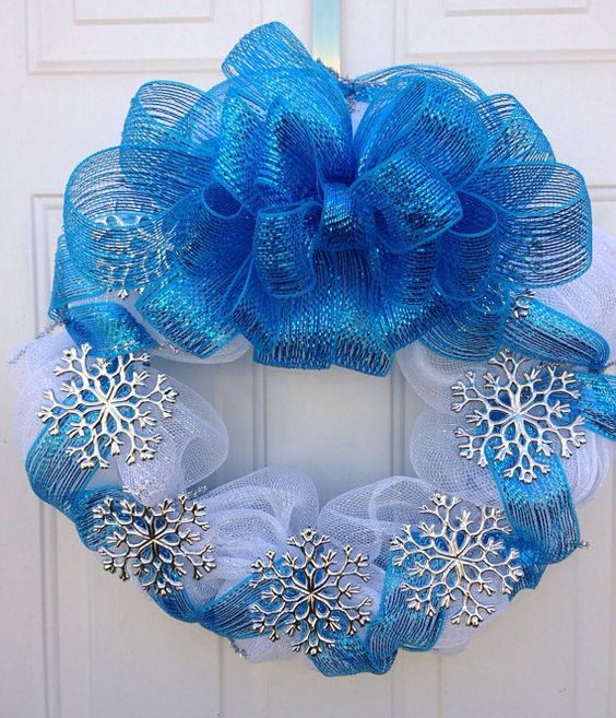 a blue and white deco mesh wreath with silver snowflakes