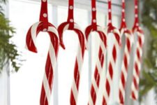 18 candy canes hanging from an evergreen garland are ideal for holidays