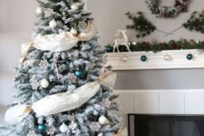 18 emerald and white ornaments and fabric garlands look eye-catching
