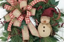 18 vintage-inspired wreath with a burlap bow and a snowman