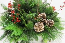 19 a bark wrapped centerpiece with evergreens, branches, berries and pincones